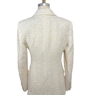 Rear view of the Chanel Cruise 2019 Runway Look 26 ivory fantasy tweed jacket showing clean tailoring, structured shoulders, and refined silhouette.