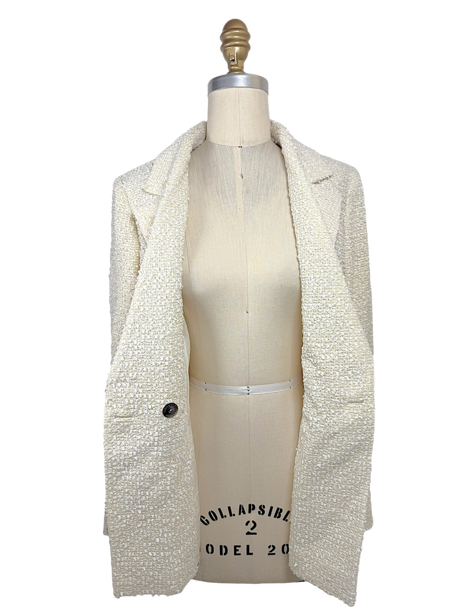 Interior front view of the authentic Chanel Cruise 2019 ivory fantasy tweed runway jacket showing premium construction, silk lining, and finished tailoring.