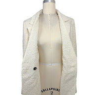 Interior front view of the authentic Chanel Cruise 2019 ivory fantasy tweed runway jacket showing premium construction, silk lining, and finished tailoring.