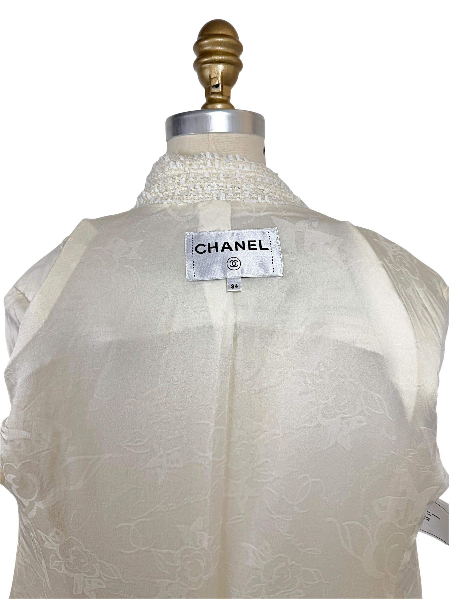Authentic Chanel interior label identifying the Cruise 2019 runway jacket in French size 34 with signature woven branding.