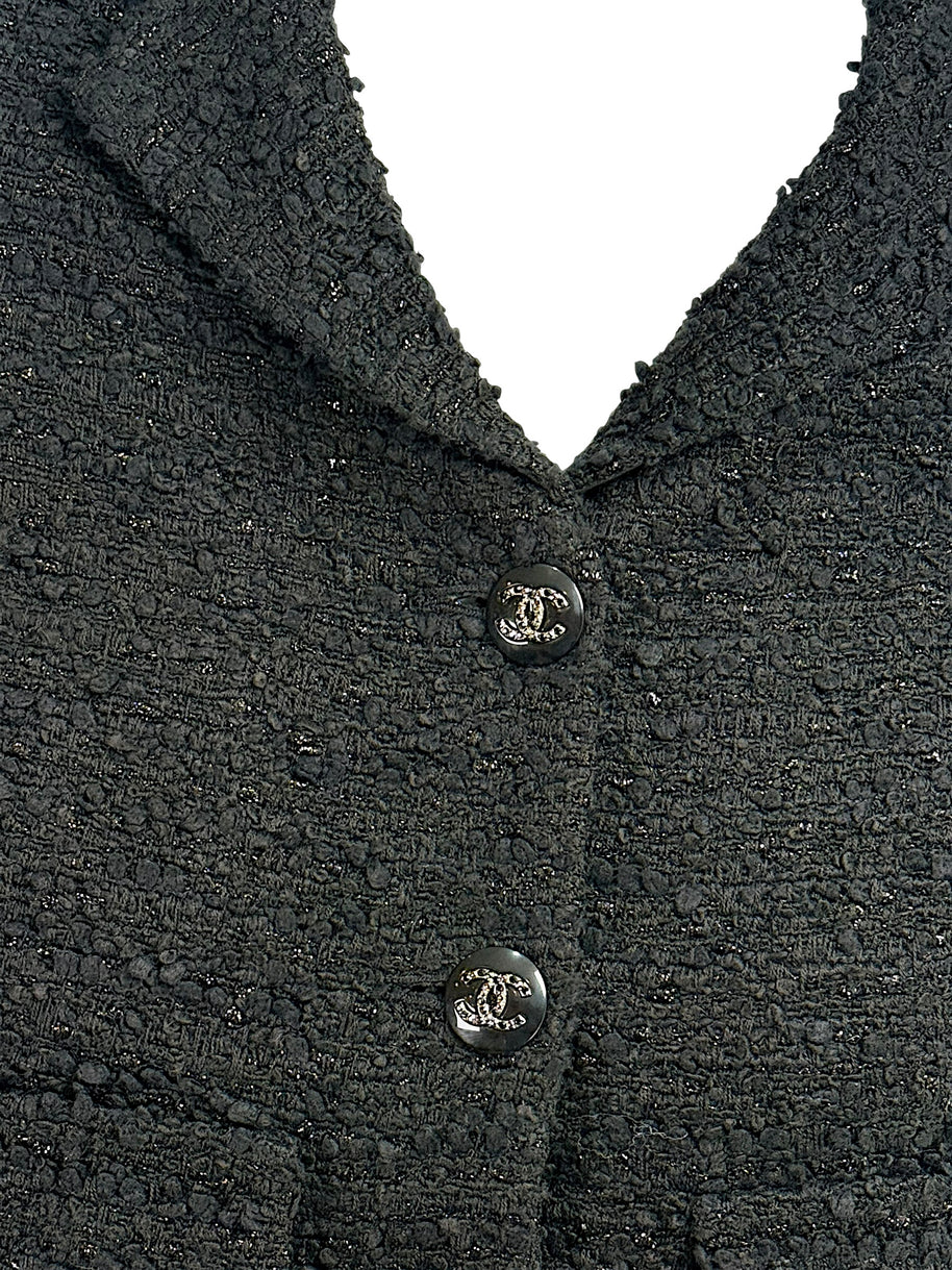 Detailed close-up of textured black bouclé tweed fabrication on Chanel Cruise 2021 runway jacket