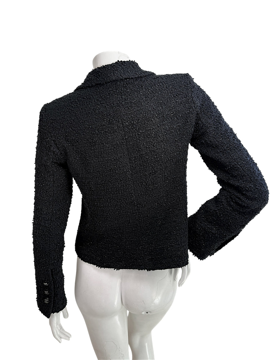 Back view of Chanel Cruise 2021 black bouclé tweed jacket with structured tailoring and silk lining