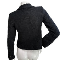 Back view of Chanel Cruise 2021 black bouclé tweed jacket with structured tailoring and silk lining
