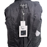 Interior view of Chanel Cruise 2021 black bouclé jacket showing Chanel boutique tags and silk lining