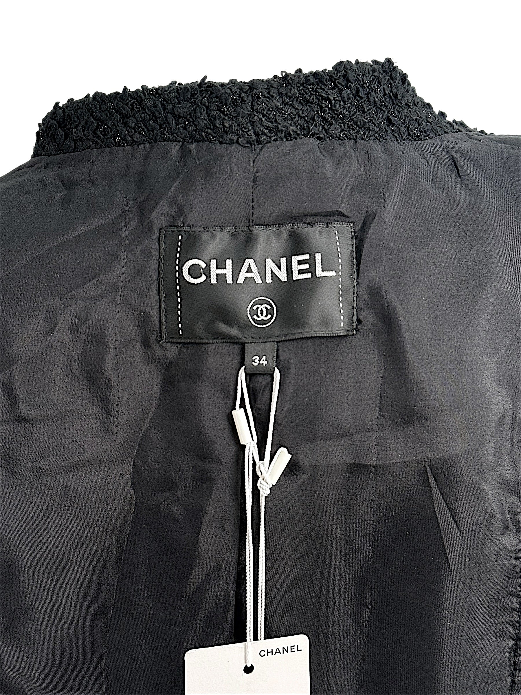 Interior Chanel neck label and size tag inside Cruise 2021 black bouclé tweed jacket