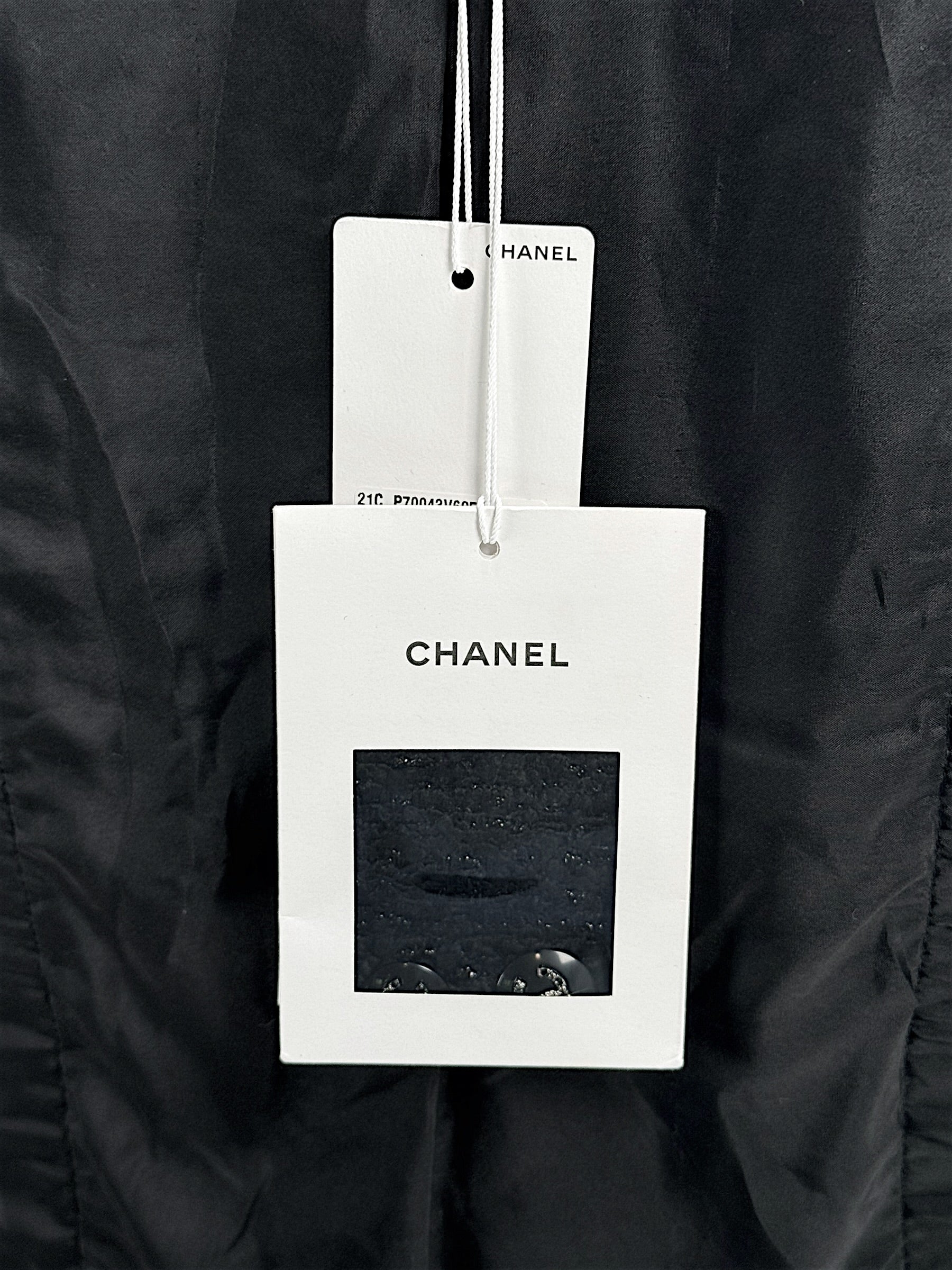Original Chanel hang tags attached to Cruise 2021 black bouclé tweed runway jacket