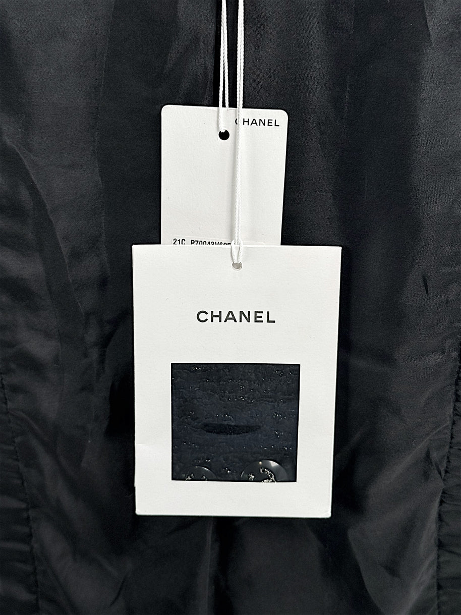 Original Chanel hang tags attached to Cruise 2021 black bouclé tweed runway jacket