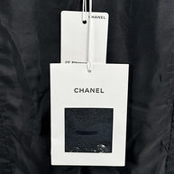 Original Chanel hang tags attached to Cruise 2021 black bouclé tweed runway jacket