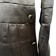Close-up condition detail of vintage Chanel black satin dress showing minor pulls consistent with age and use.