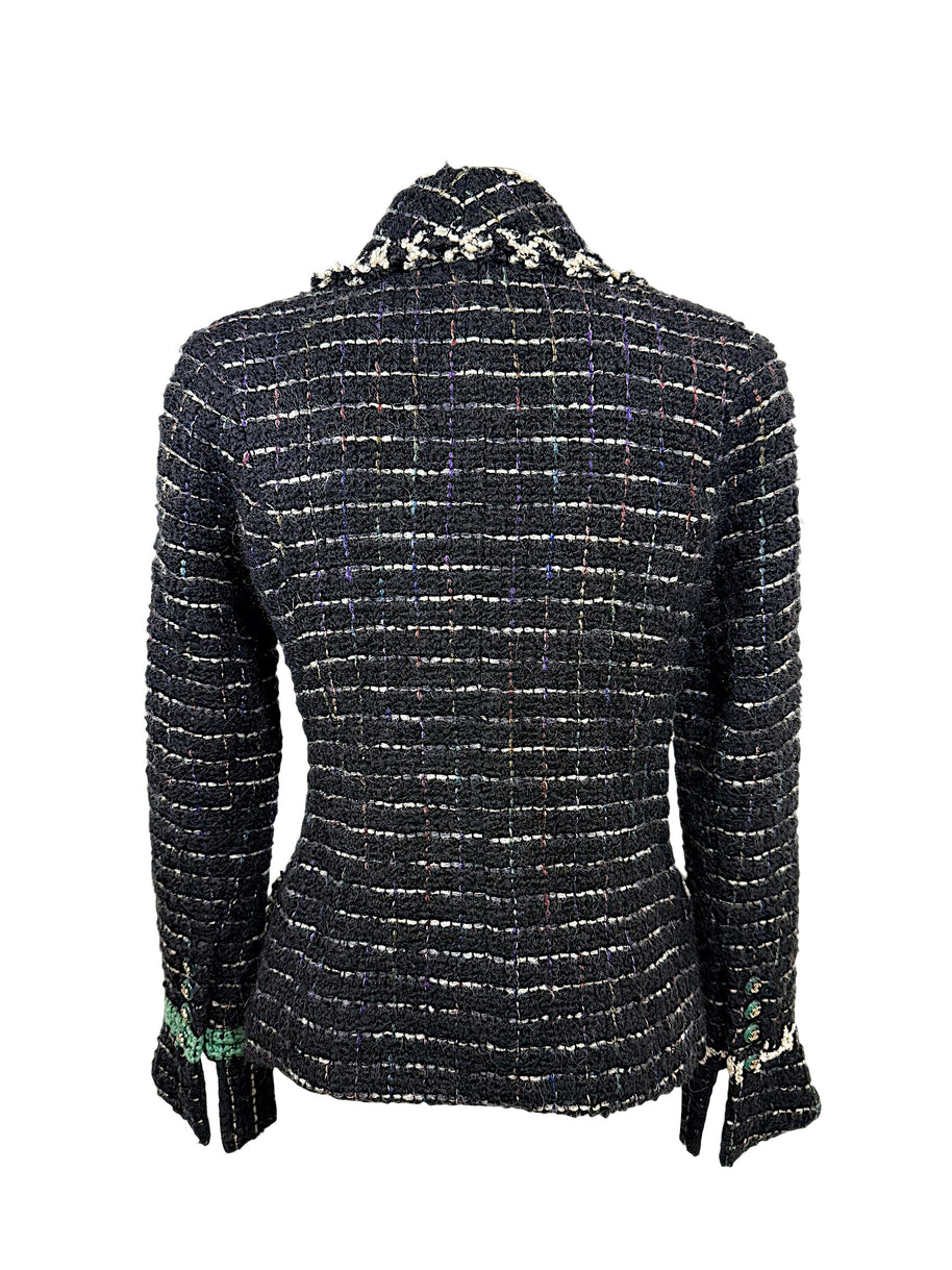 Rear view of Chanel Fall 2009 Runway Look 22 black bouclé tweed jacket showcasing tailored silhouette and textured fantasy tweed construction.