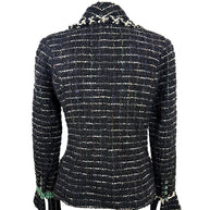 Rear view of Chanel Fall 2009 Runway Look 22 black bouclé tweed jacket showcasing tailored silhouette and textured fantasy tweed construction.
