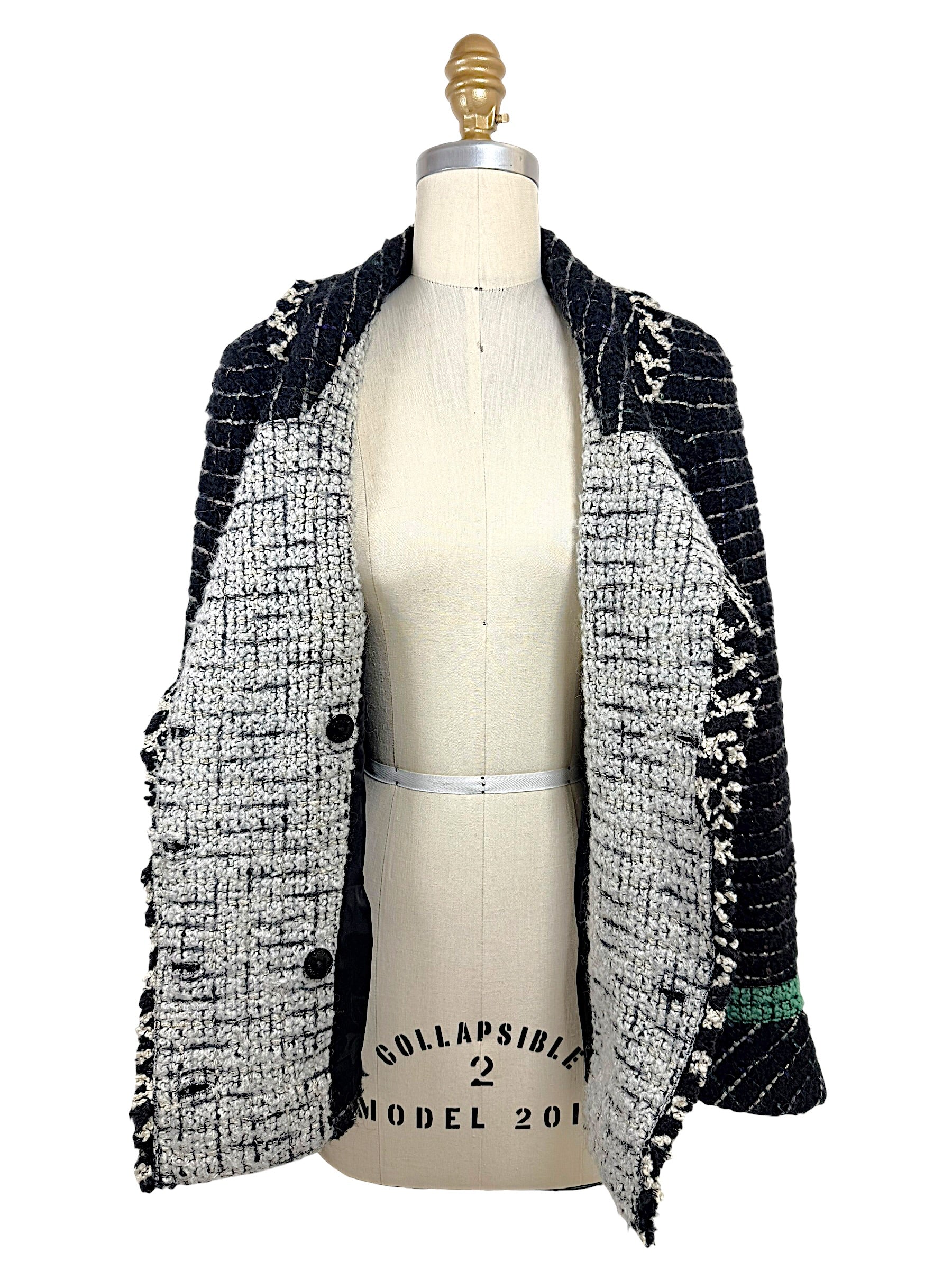 Interior construction of the Chanel Fall 2009 Runway Look 22 bouclé tweed jacket showing the reverse weave, shawl collar, and couture craftsmanship.