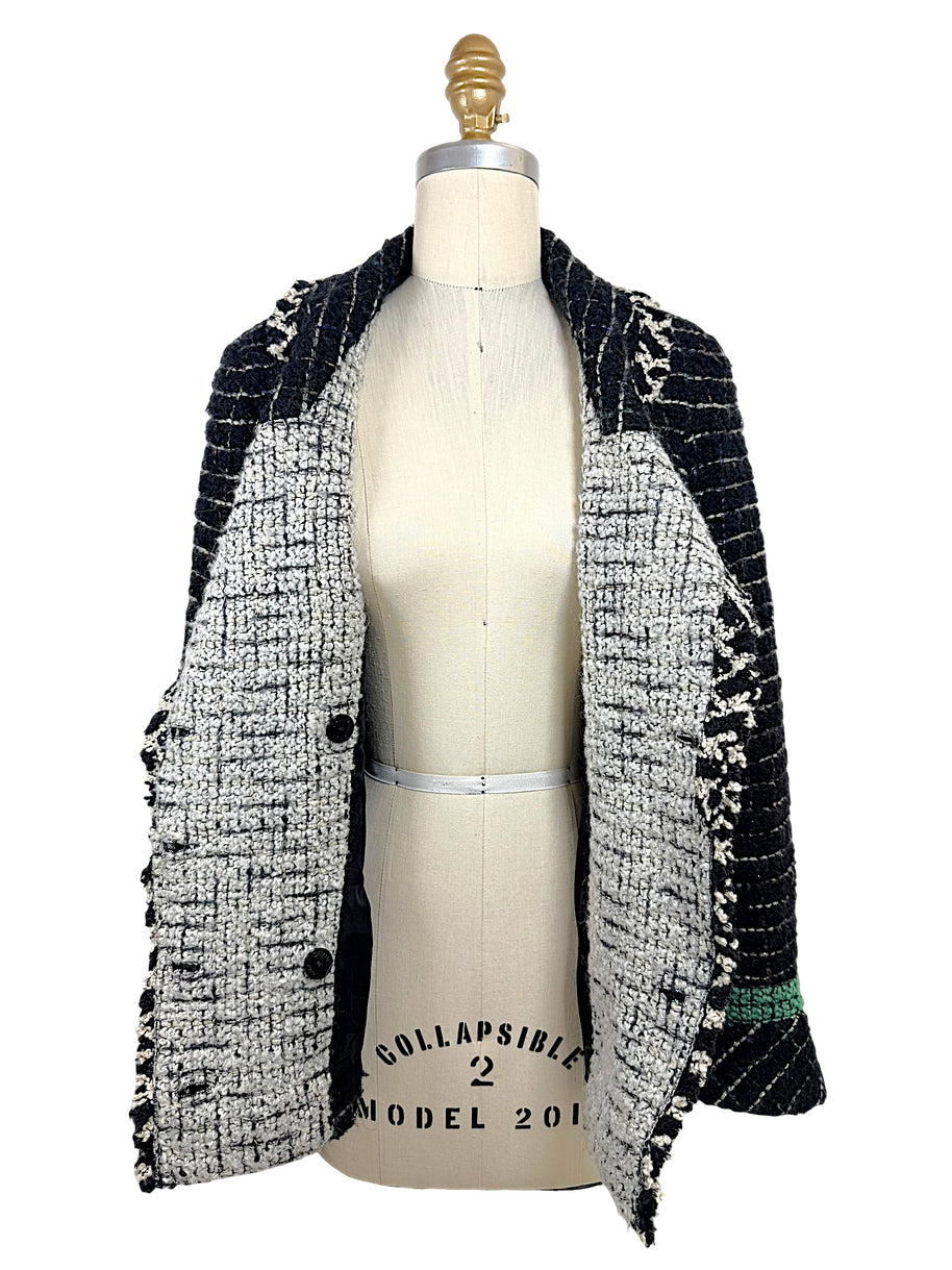 Interior construction of the Chanel Fall 2009 Runway Look 22 bouclé tweed jacket showing the reverse weave, shawl collar, and couture craftsmanship.