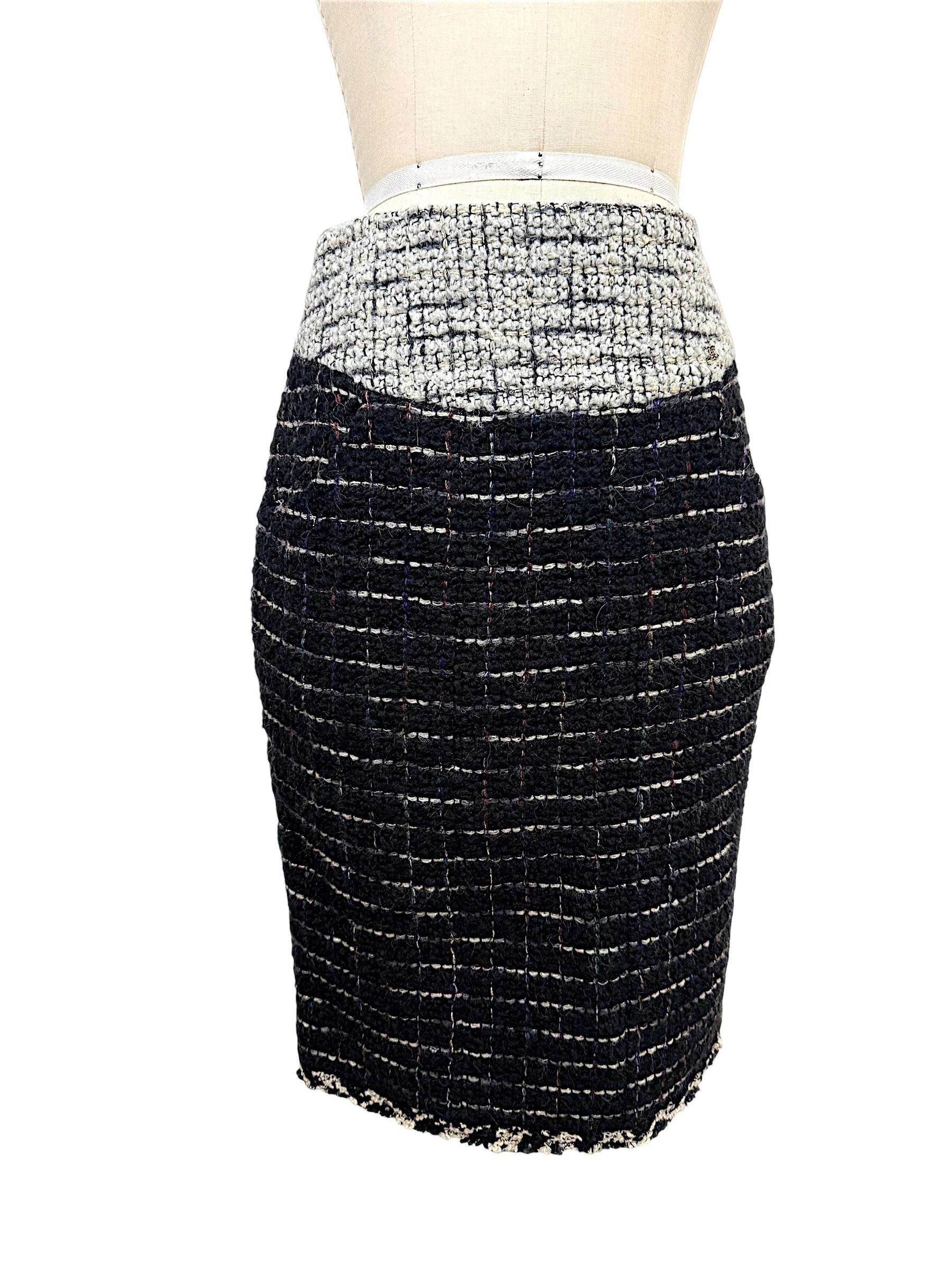 Front view of matching Chanel Fall 2009 black bouclé tweed pencil skirt with ivory waistband detail from documented Runway Look 22.