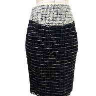 Front view of matching Chanel Fall 2009 black bouclé tweed pencil skirt with ivory waistband detail from documented Runway Look 22.