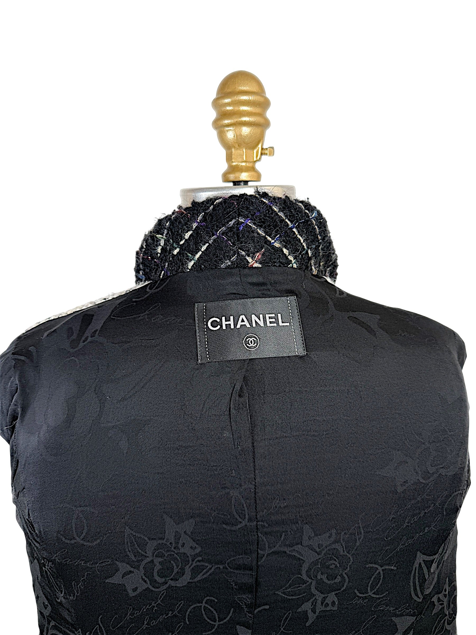 Close-up of authentic Chanel label sewn into the black CC jacquard silk lining of the Fall 2009 Runway Look 22 jacket.