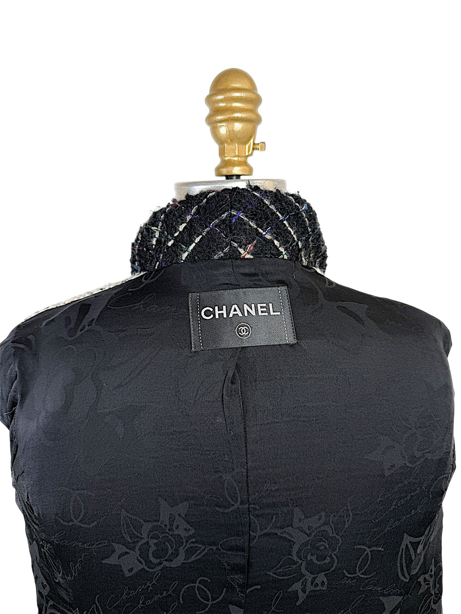 Close-up of authentic Chanel label sewn into the black CC jacquard silk lining of the Fall 2009 Runway Look 22 jacket.
