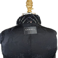 Close-up of authentic Chanel label sewn into the black CC jacquard silk lining of the Fall 2009 Runway Look 22 jacket.