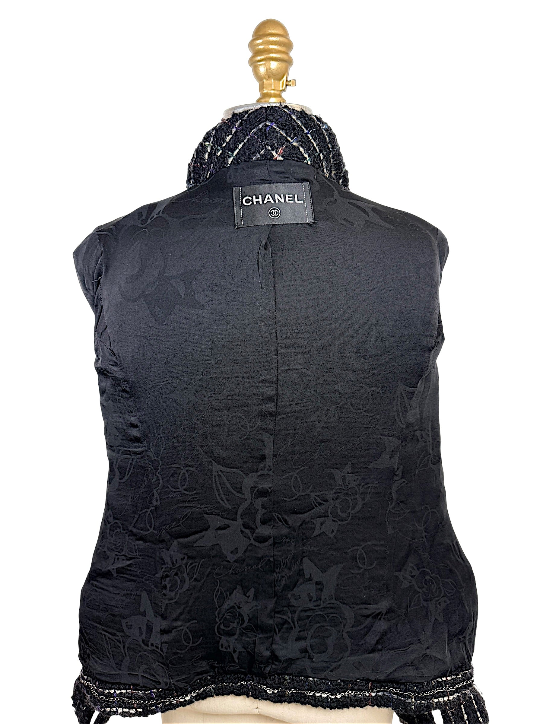 Interior of Chanel Fall 2009 Runway Look 22 jacket featuring black CC logo jacquard silk lining and signature Chanel label.