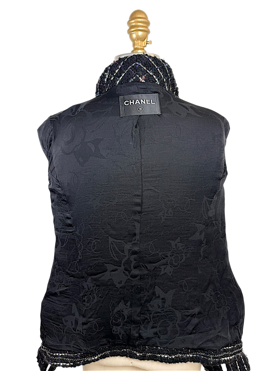 Interior of Chanel Fall 2009 Runway Look 22 jacket featuring black CC logo jacquard silk lining and signature Chanel label.