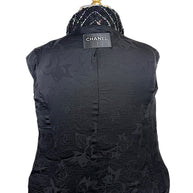 Interior of Chanel Fall 2009 Runway Look 22 jacket featuring black CC logo jacquard silk lining and signature Chanel label.