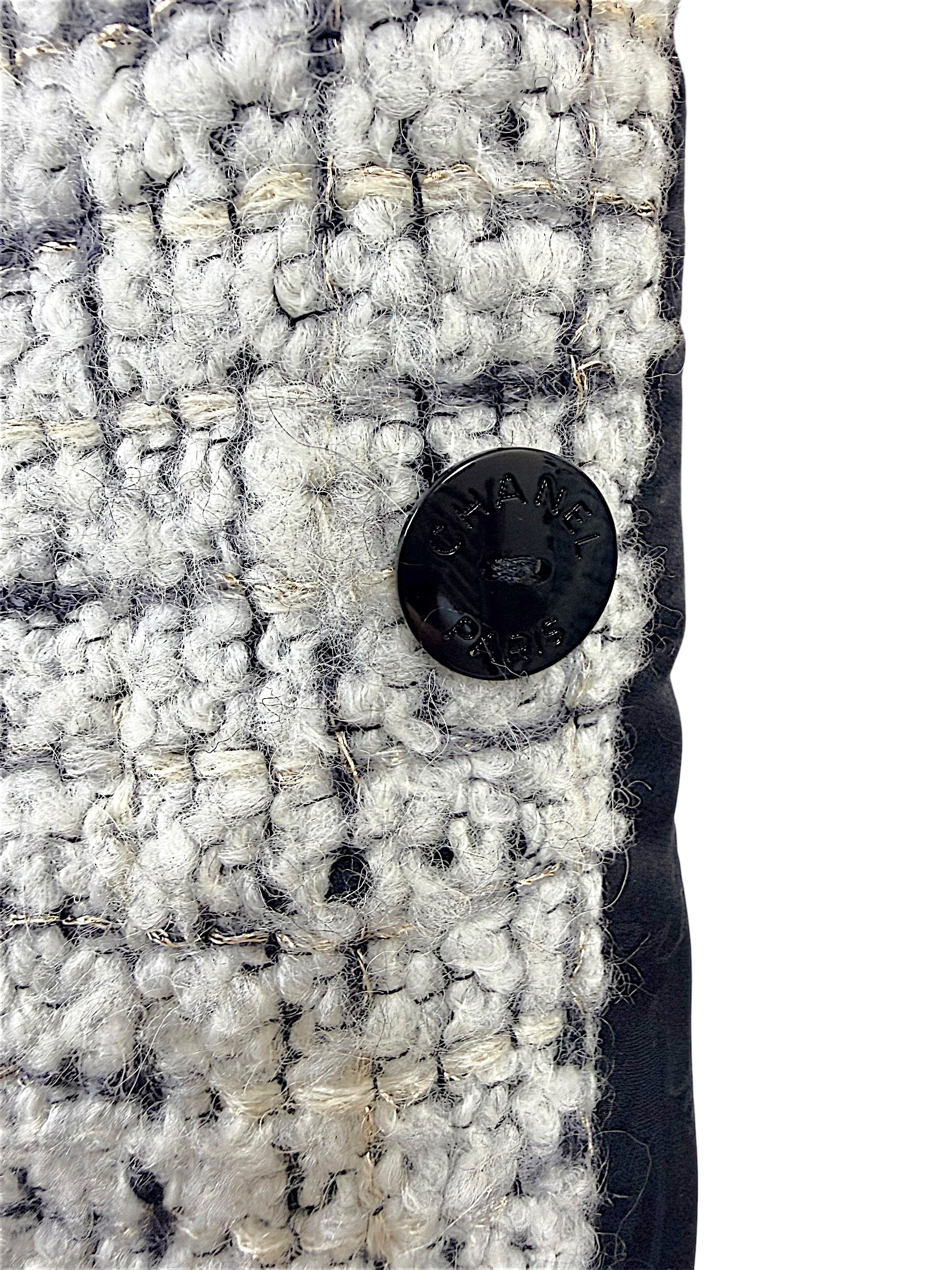 Close-up of the interior Chanel Paris button on the reverse side of the Fall 2009 Runway Look 22 bouclé jacket.