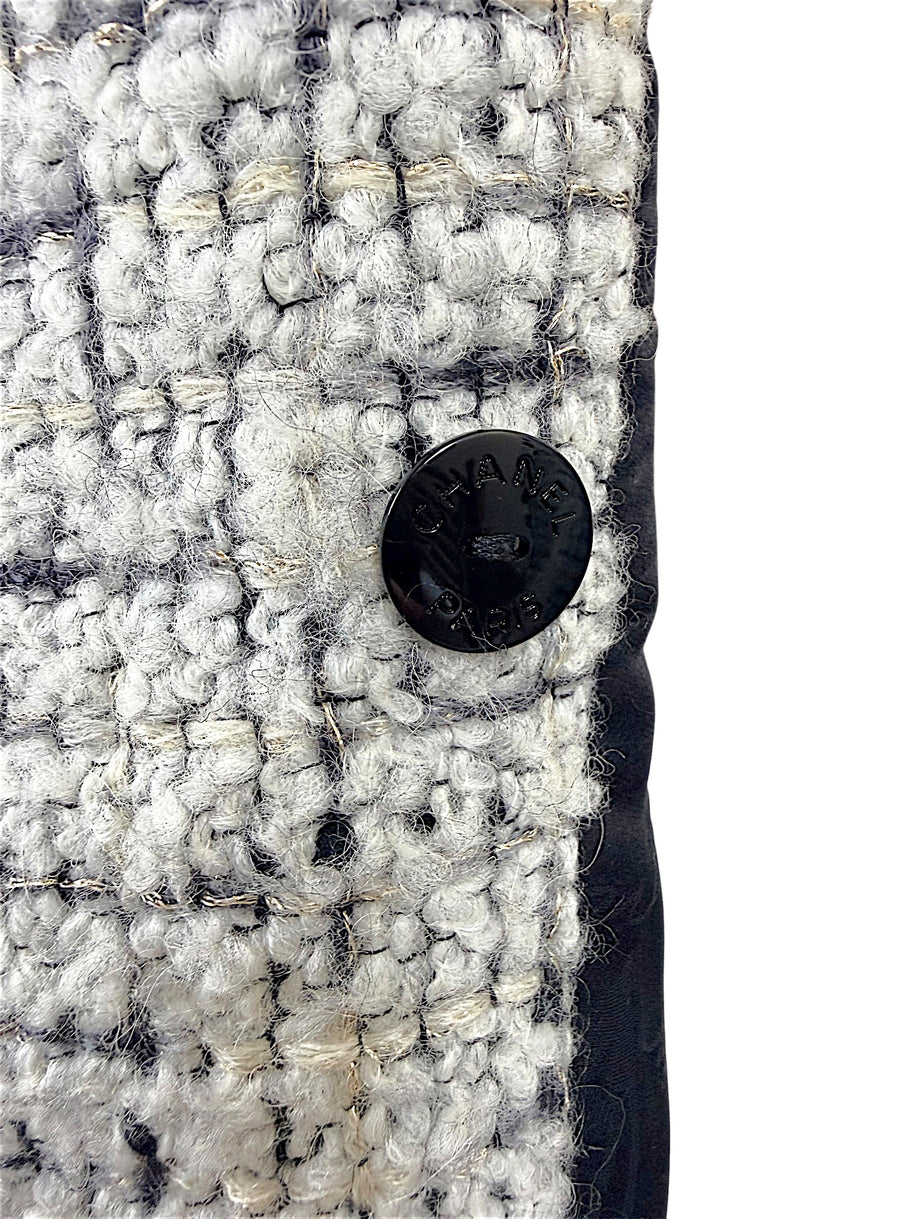 Close-up of the interior Chanel Paris button on the reverse side of the Fall 2009 Runway Look 22 bouclé jacket.