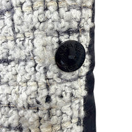 Close-up of the interior Chanel Paris button on the reverse side of the Fall 2009 Runway Look 22 bouclé jacket.