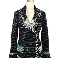Front view of Chanel Fall 2009 Runway Look 22 black bouclé tweed jacket with shawl collar, ivory fringe trim, emerald green woven accents, and enamel CC buttons.