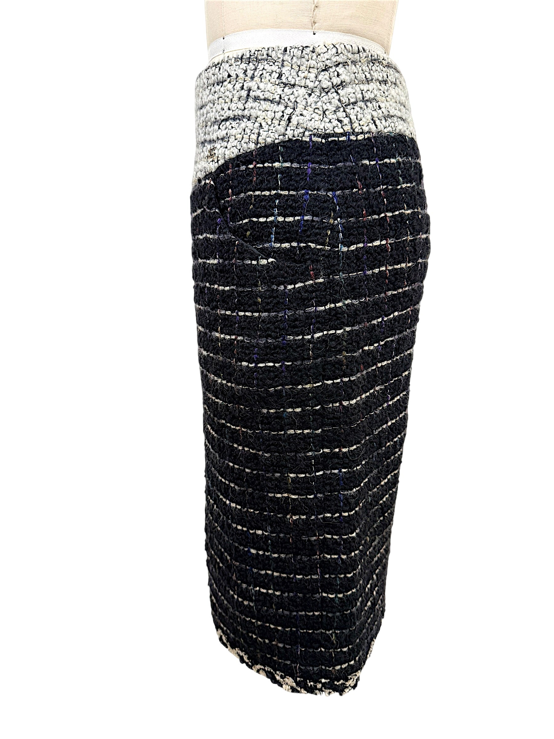 Opposite side view of the Chanel Fall 2009 Runway Look 22 black fantasy bouclé tweed pencil skirt highlighting the sculpted fit and textured weave.