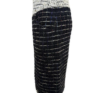 Opposite side view of the Chanel Fall 2009 Runway Look 22 black fantasy bouclé tweed pencil skirt highlighting the sculpted fit and textured weave.