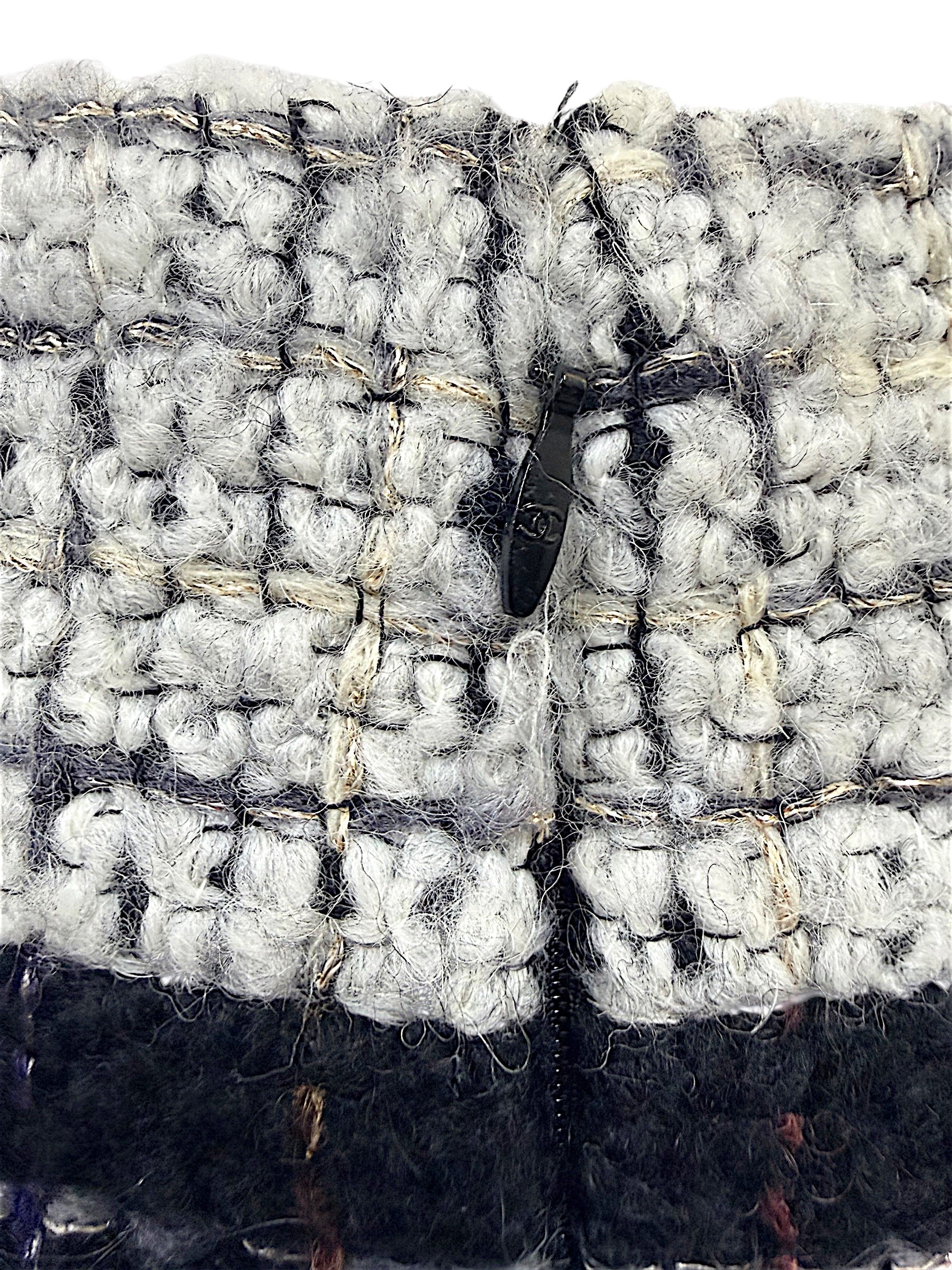 Close-up of the concealed waist hook and zipper closure on the Chanel Fall 2009 Runway Look 22 bouclé tweed skirt.