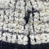 Close-up of the concealed waist hook and zipper closure on the Chanel Fall 2009 Runway Look 22 bouclé tweed skirt.