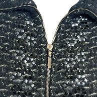 Detailed close-up of Chanel Fall Winter 2010 appliqué embellishment and front zip closure