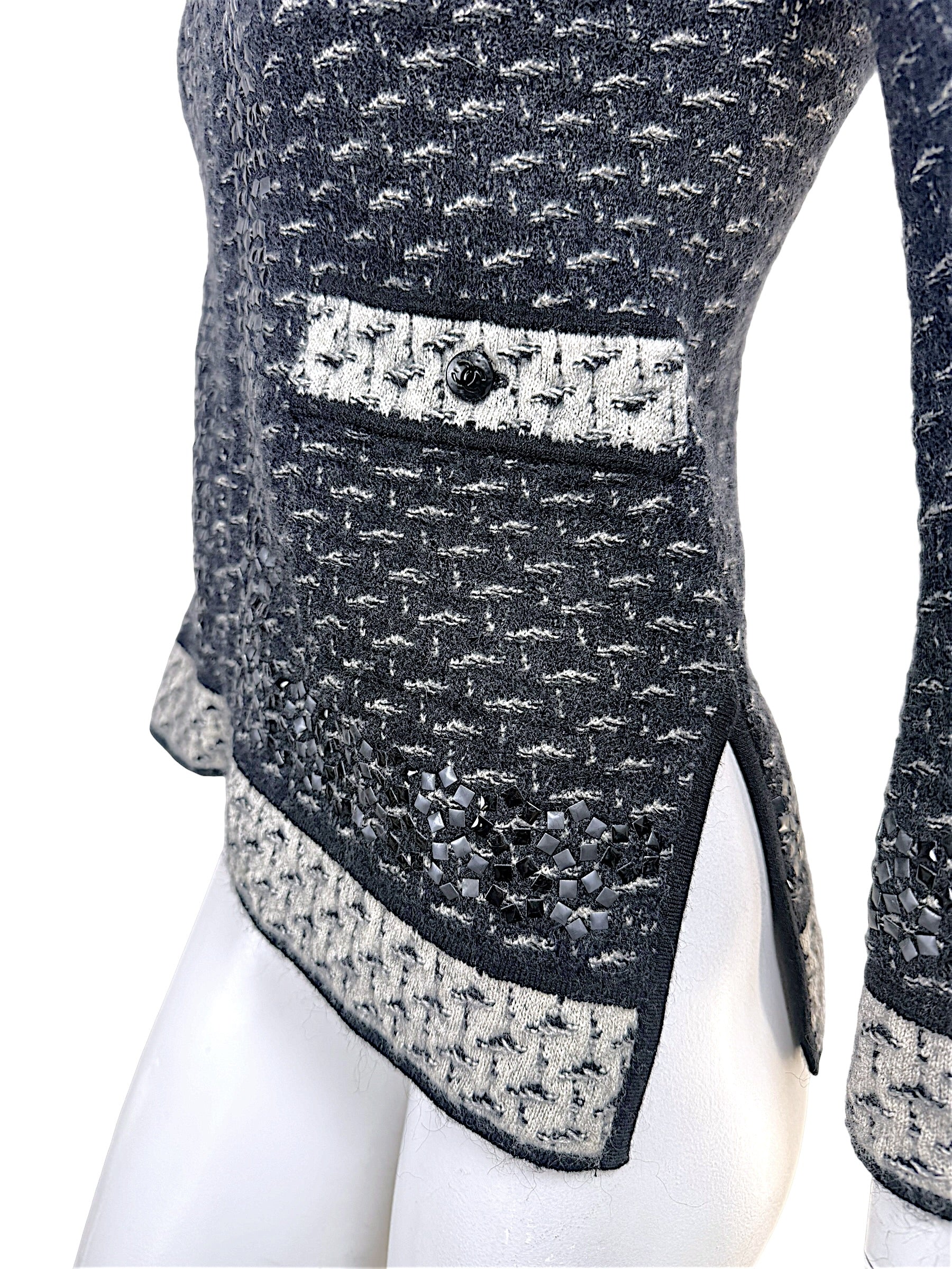 Close-up detail of Chanel CC pocket accent and appliqué embellished hem