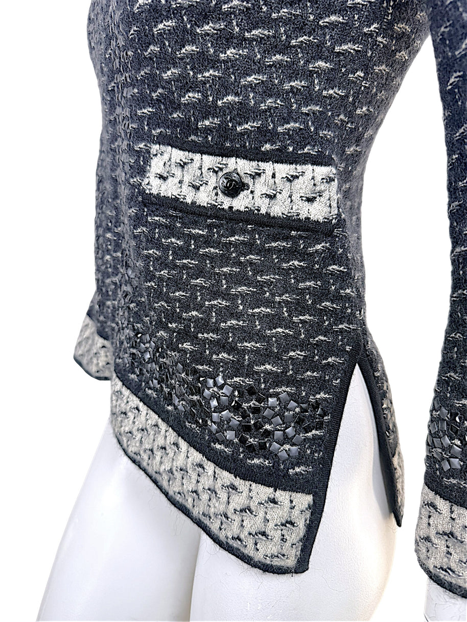 Close-up detail of Chanel CC pocket accent and appliqué embellished hem
