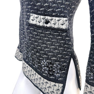 Close-up detail of Chanel CC pocket accent and appliqué embellished hem