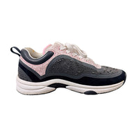 Chanel grey and pink tweed sneaker side view showing oversized tonal interlocking CC logo