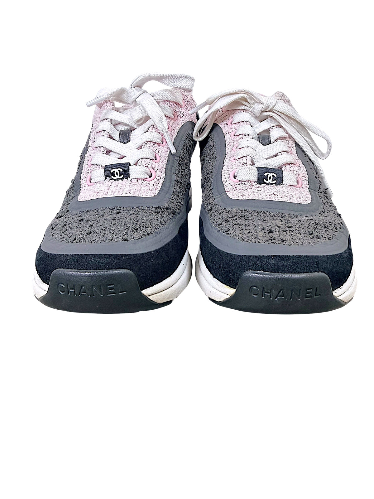 Front view of Chanel pink and grey tweed sneakers with CC lace tabs and Chanel toe branding