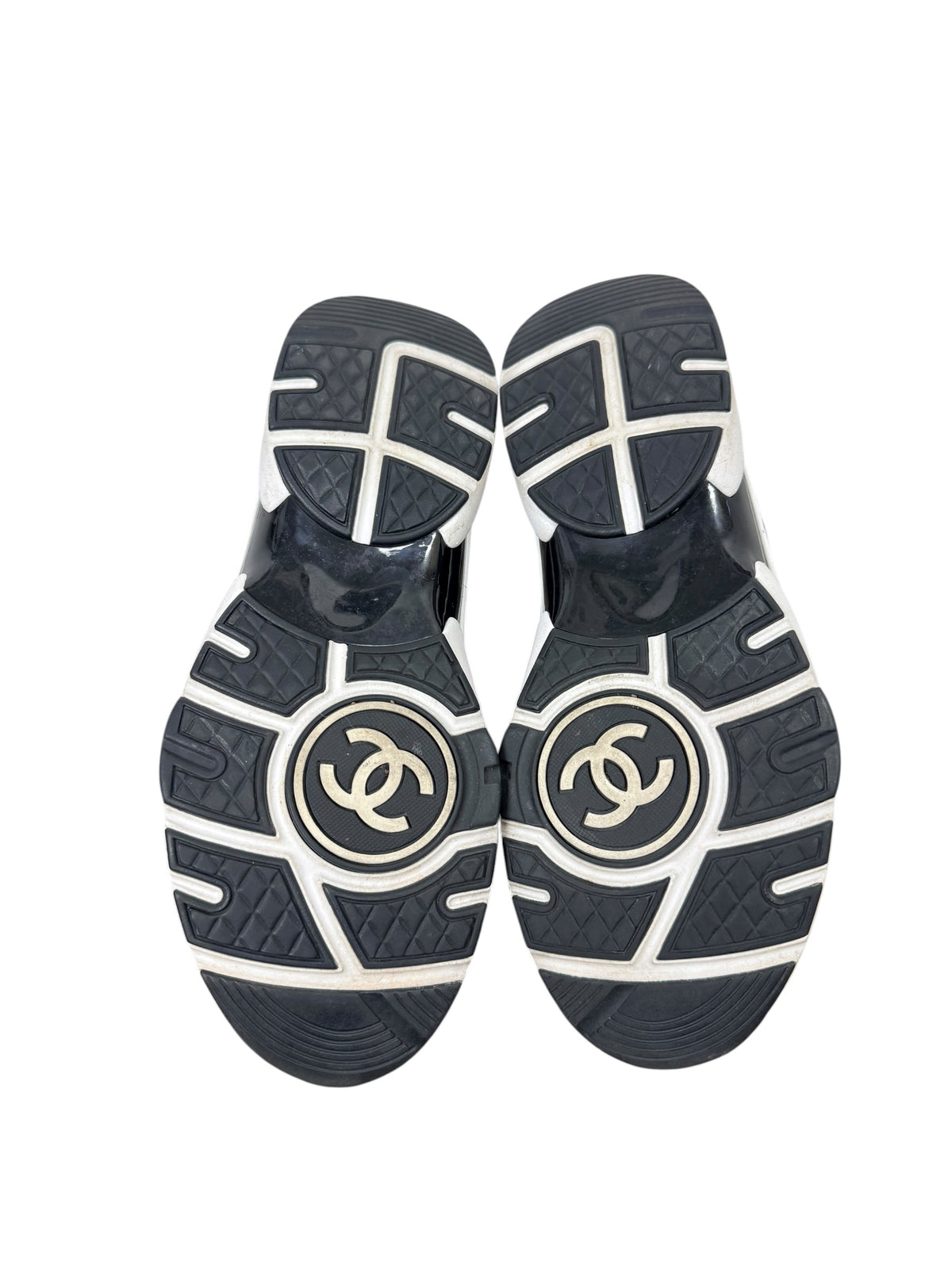 Chanel G34360 sneaker outsoles showing interlocking CC logos and wear consistent with age and use