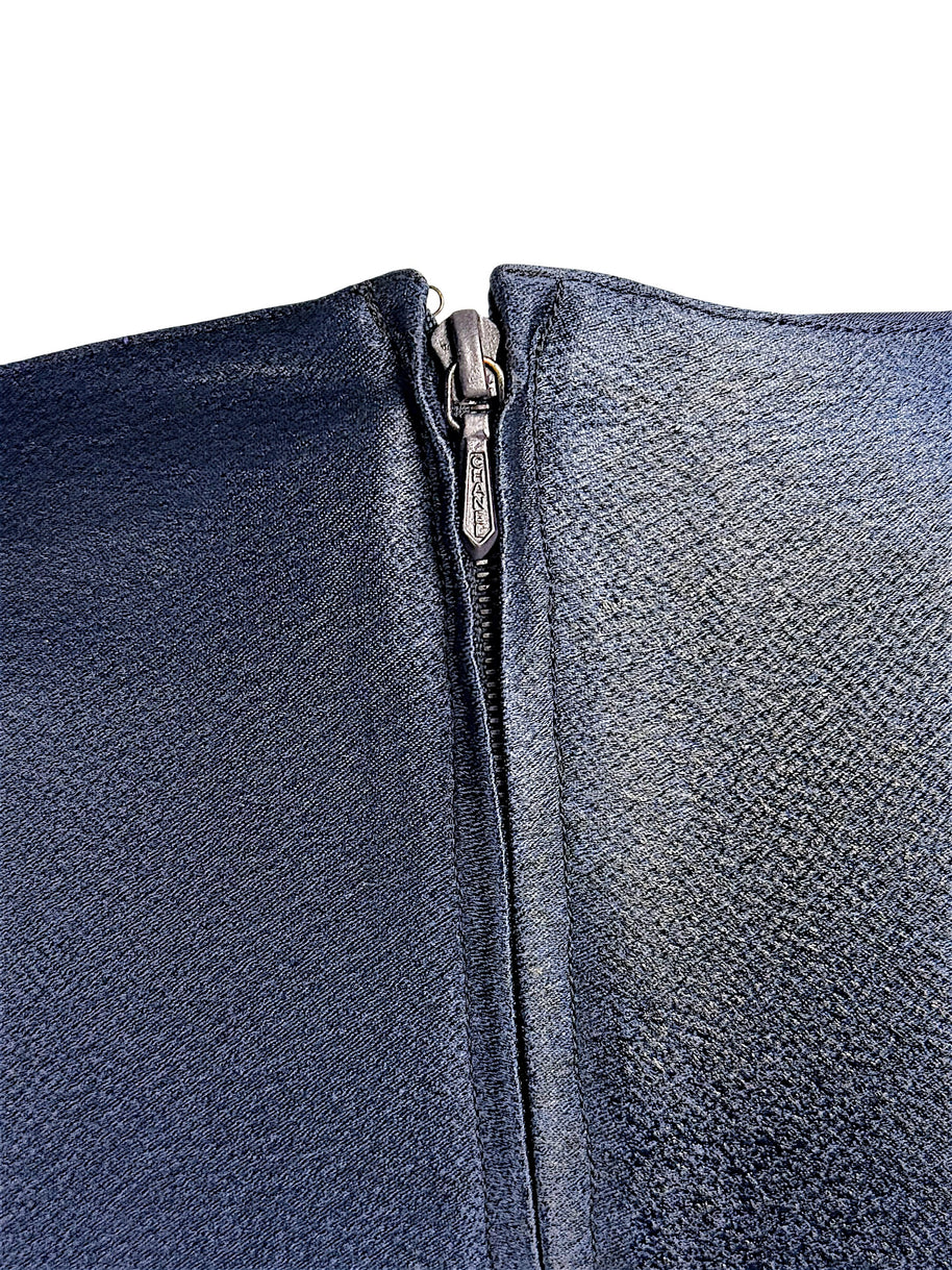 Close-up detail of vintage Chanel navy metallic garment zipper closure and textured fabric finish.