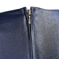 Close-up detail of vintage Chanel navy metallic garment zipper closure and textured fabric finish.