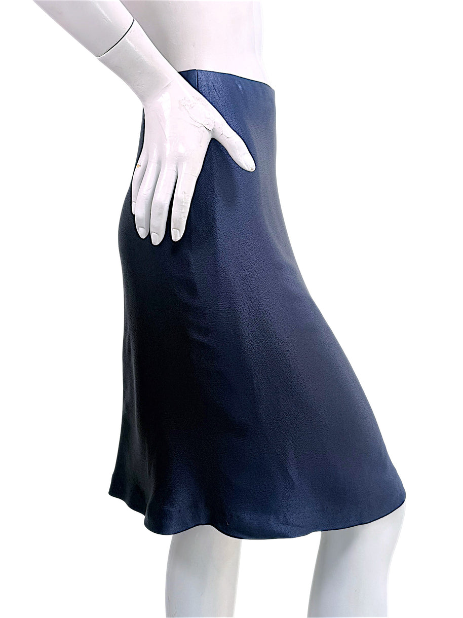 Side profile view of Chanel Identification Collection navy metallic skirt showing soft movement and silhouette.