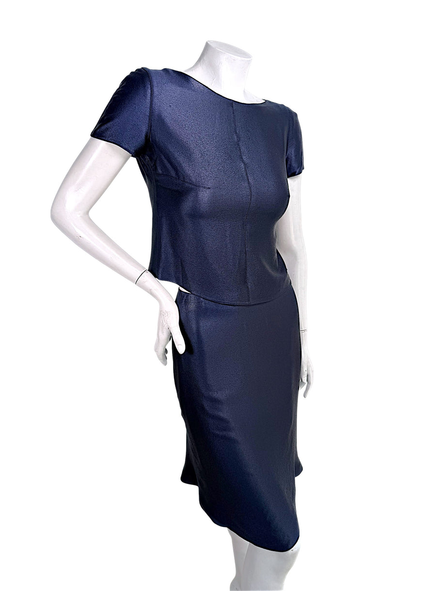 Three-quarter front view of Chanel Identification Collection navy metallic two-piece skirt set with minimalist silhouette.