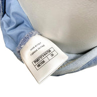 Chanel made in Italy interior garment tag showing collection code and size information for Spring 2006 denim jeans.