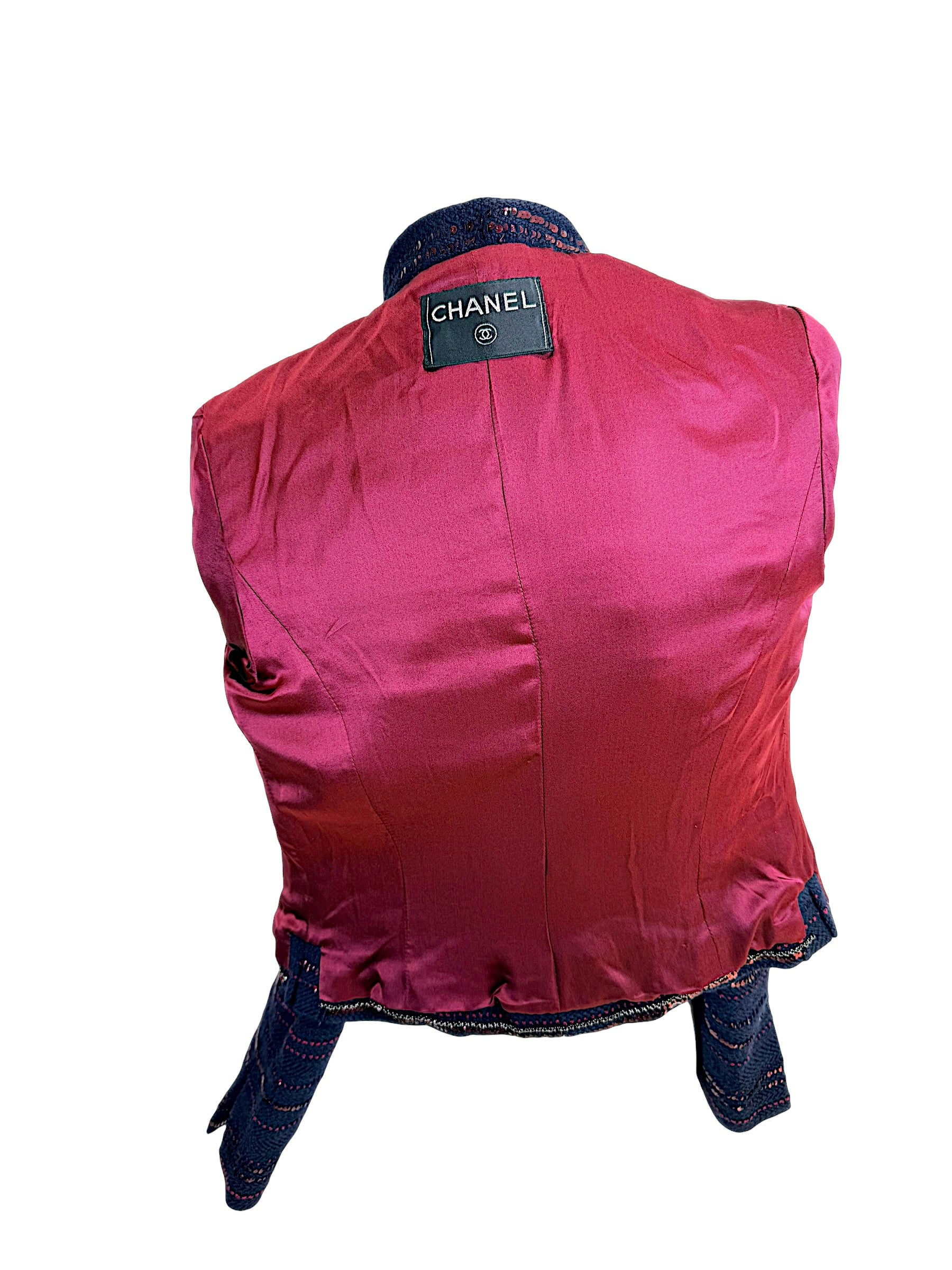 Chanel navy tweed jacket back view with structured seams and burgundy sequin accents