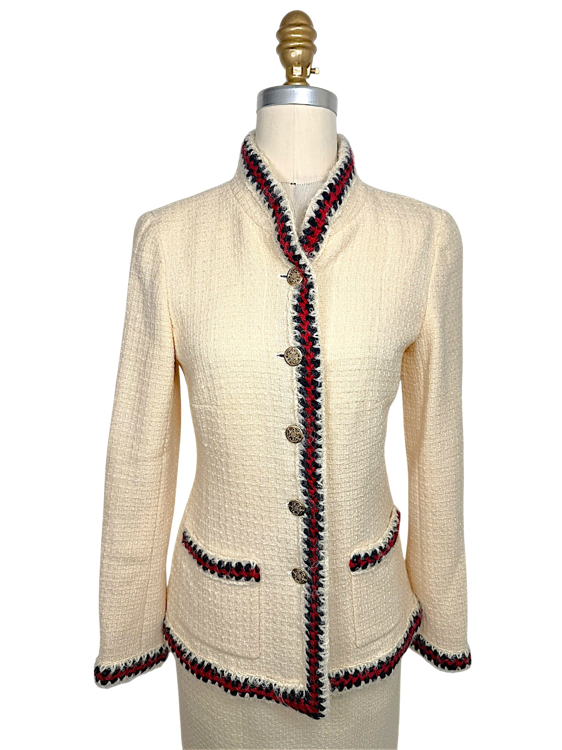 Front view of Chanel Pre-Fall 2010 ivory bouclé jacket featuring signature braided trim, stand collar, patch pockets and gold-tone Chanel buttons.