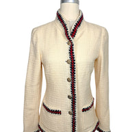 Front view of Chanel Pre-Fall 2010 ivory bouclé jacket featuring signature braided trim, stand collar, patch pockets and gold-tone Chanel buttons.