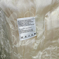 Close-up of original Chanel care instructions label inside the Pre-Fall 2010 Paris-Shanghai jacket.