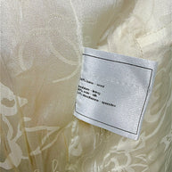 Close-up of Chanel composition label showing fabric content inside the Pre-Fall 2010 runway jacket.